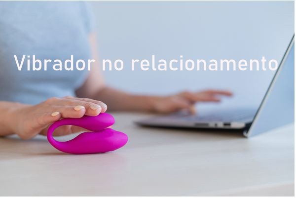 mulher digitando no notebook com uma mão e a outra apoiando um vibrador