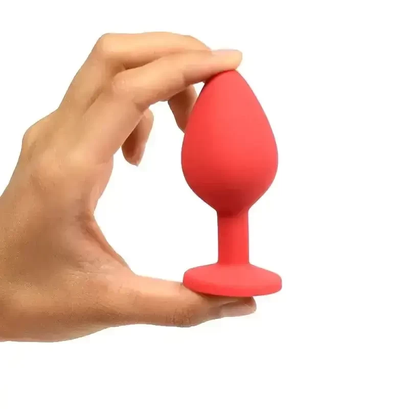 mão demonstrando a flexibilidade de Plug Anal Silicone P Com Pedra Vermelha Joia Rara